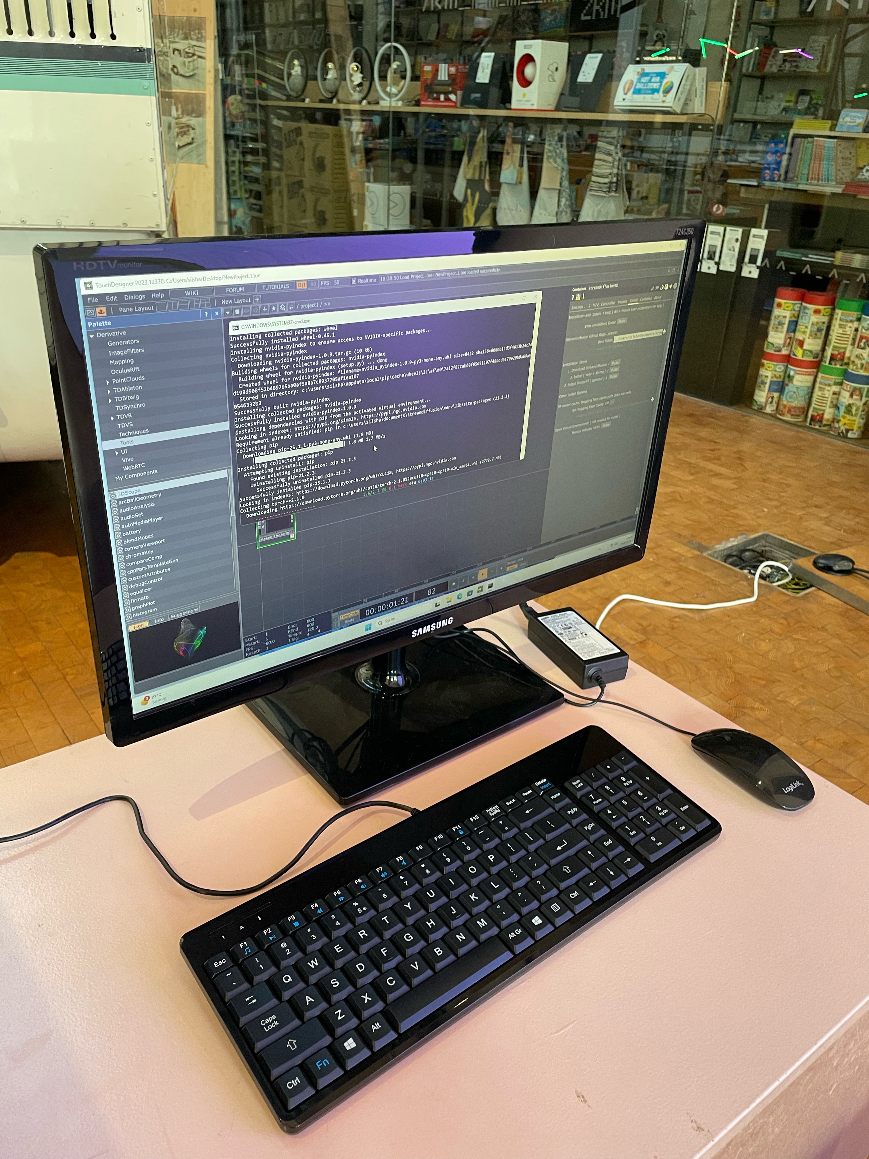Ein Computer Bildschirm zeigt ein Projekt in TouchDesigner und eine Komandozeile.
